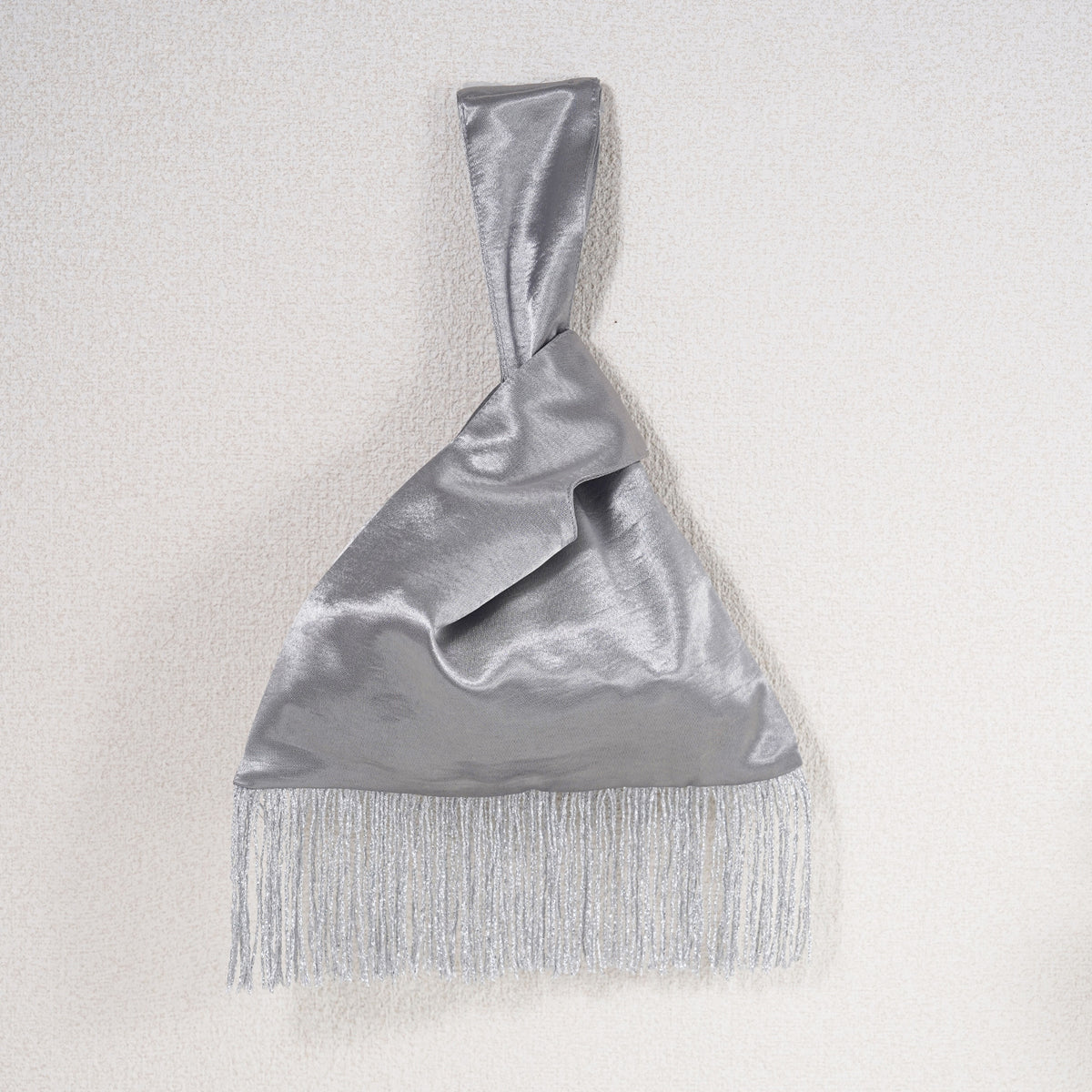 Silver acetate satin Japanese knot bag with silver metallic fringe