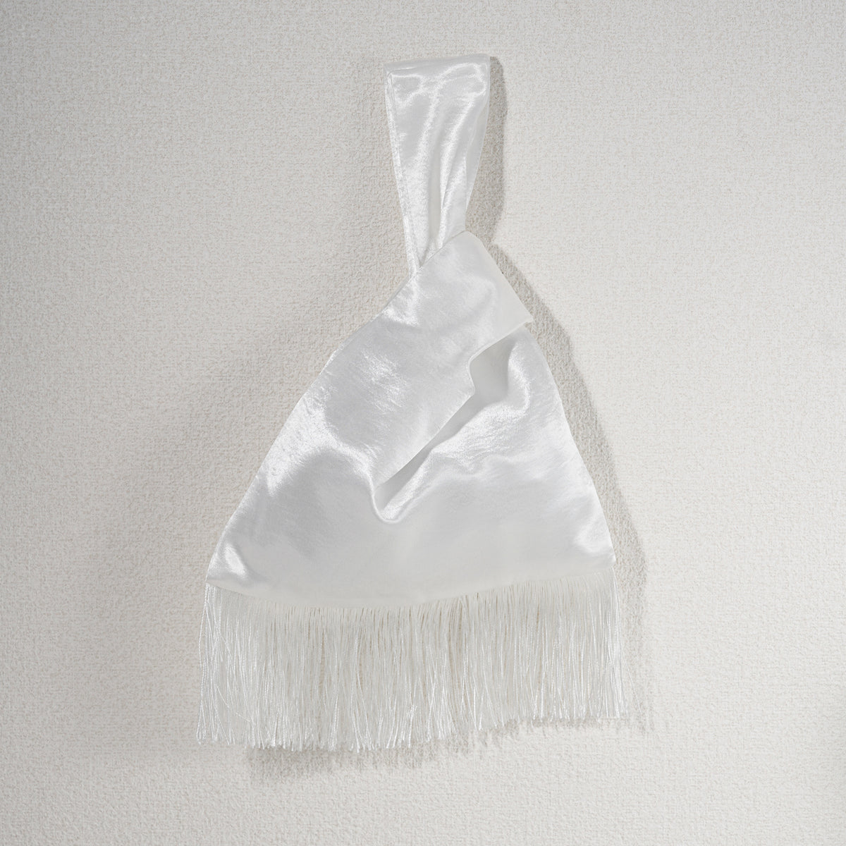 White acetate satin Japanese knot bag with white fringe