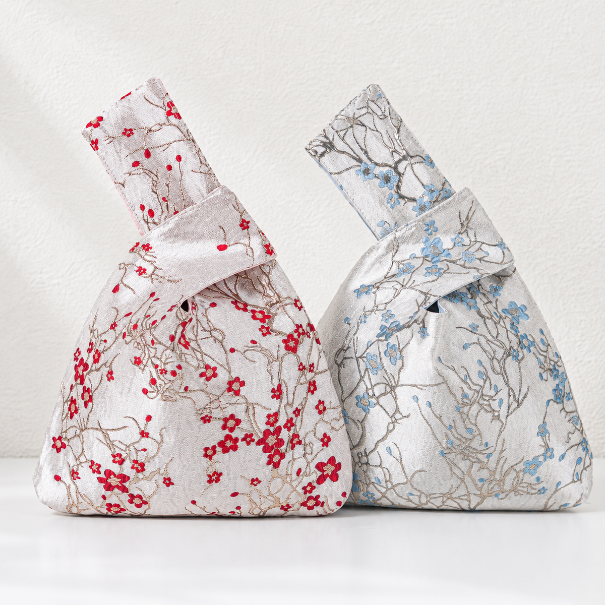 Champagne-red and silver-blue winter blossom knot bags