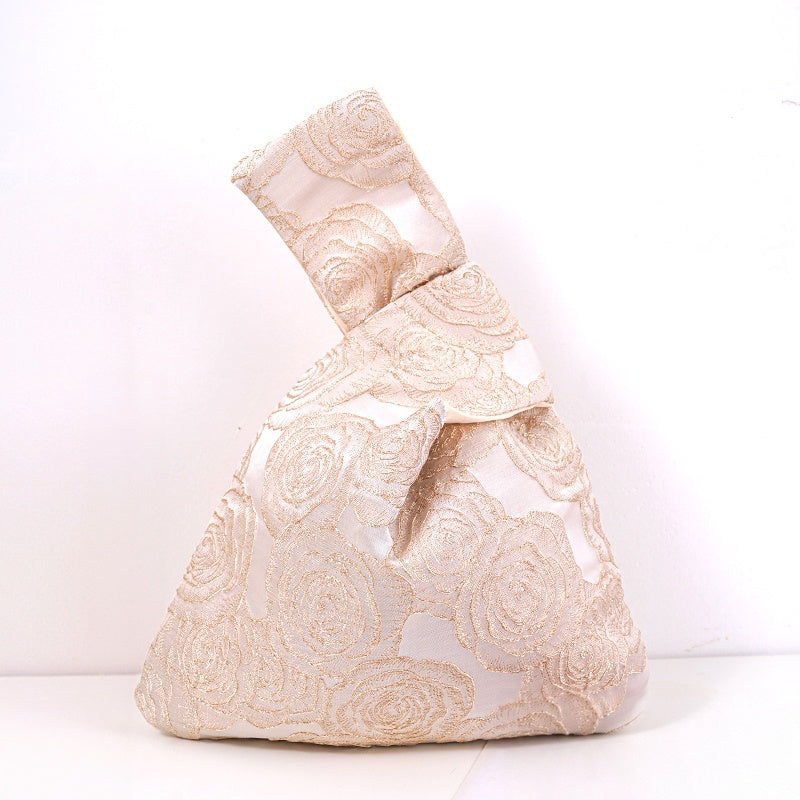 Champagne knot bag with raised gold roses