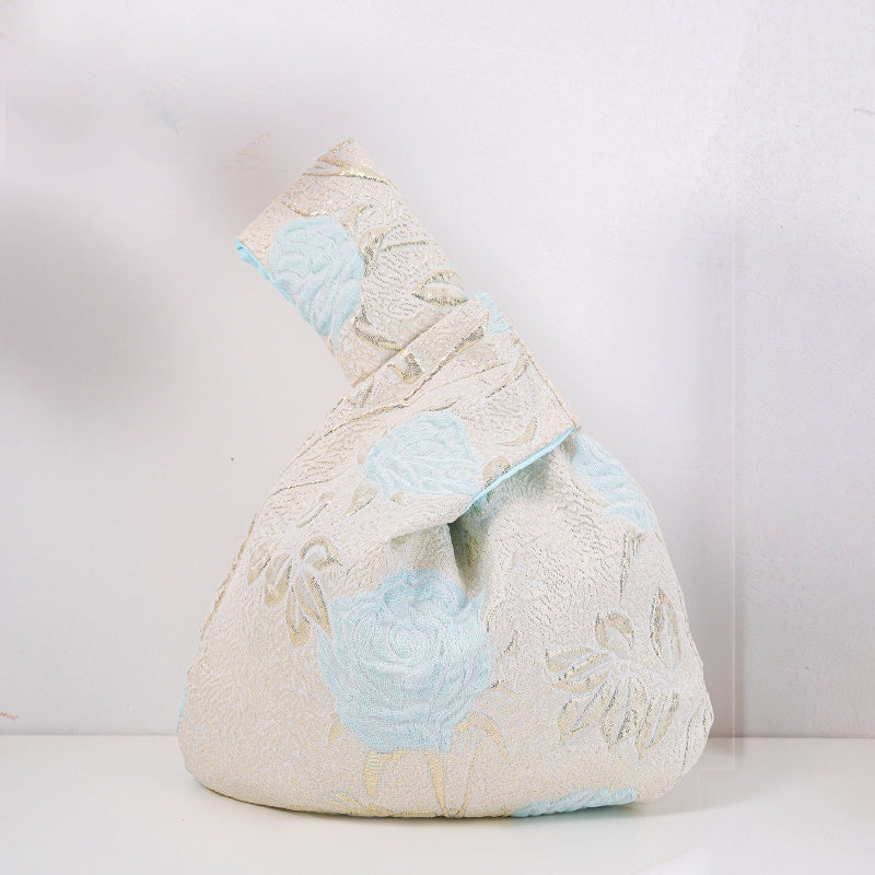 Knot bag with blue long-stem roses