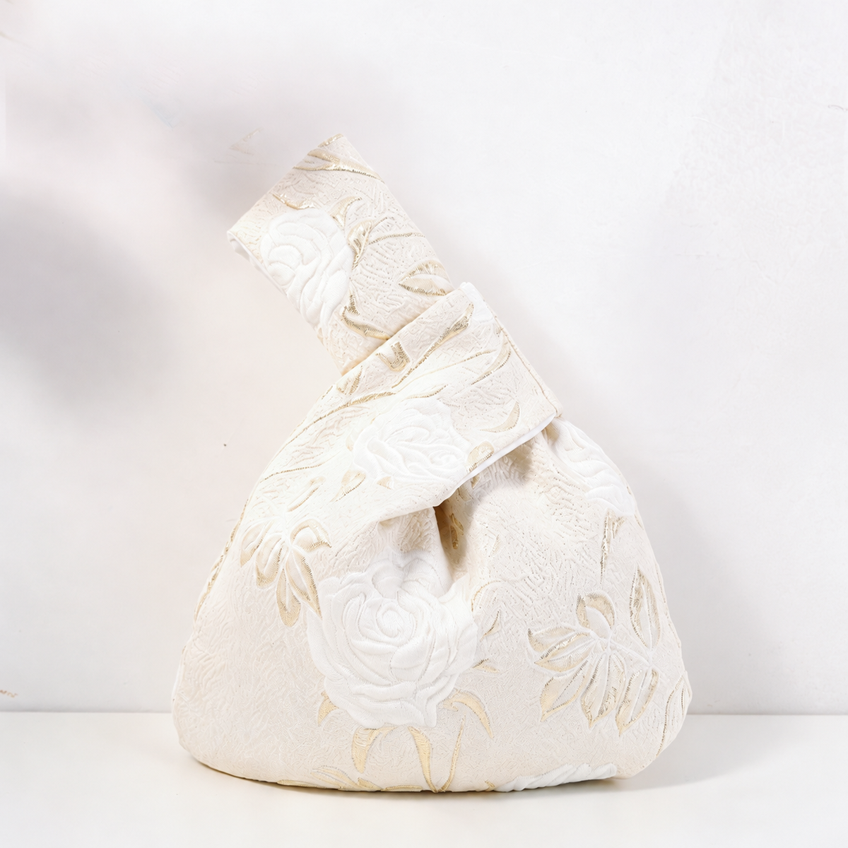 Knot bag with white long-stem roses