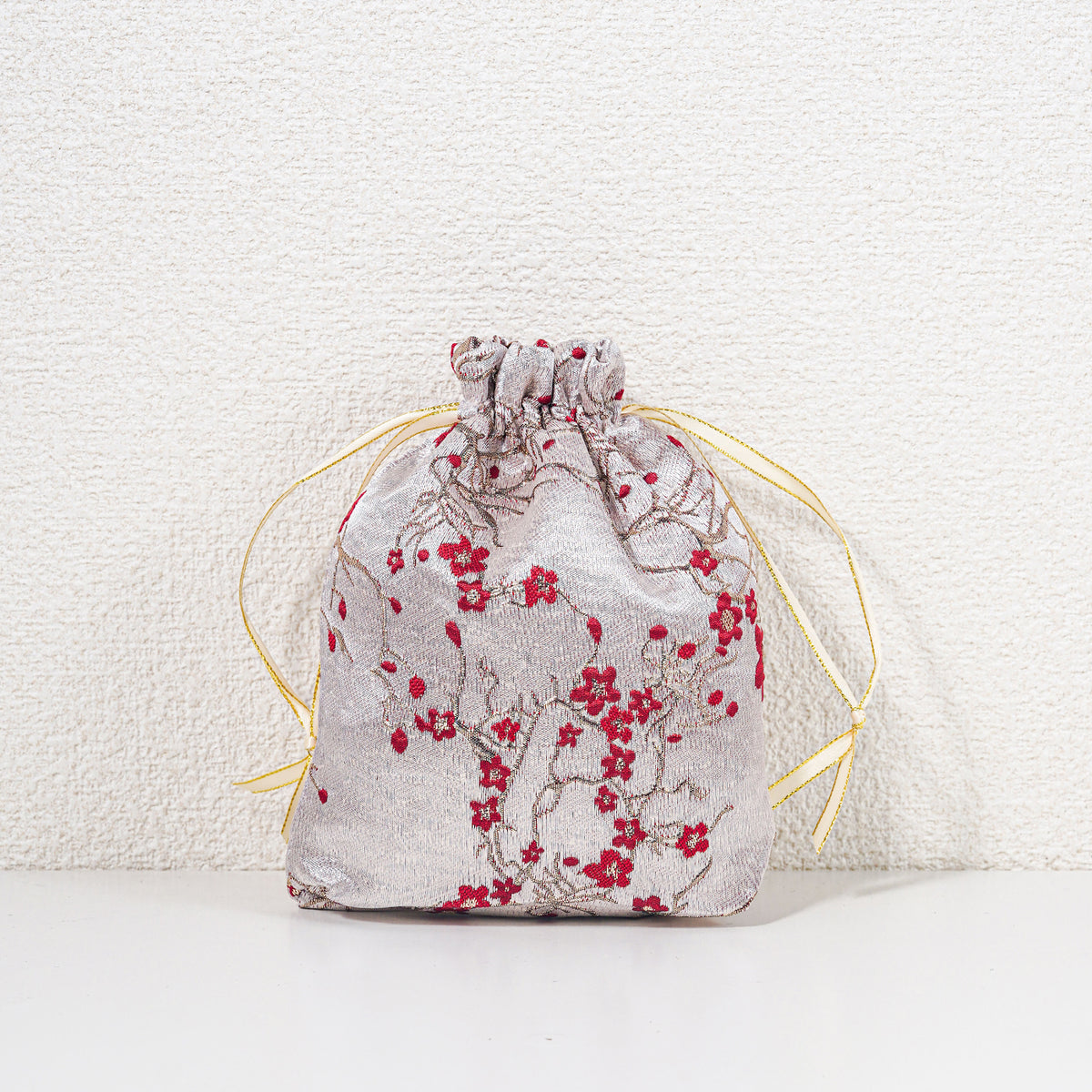 Small winter blossom drawstring gift bag, red on pale champagne