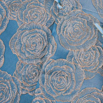 Close-up of metallic gold roses on navy