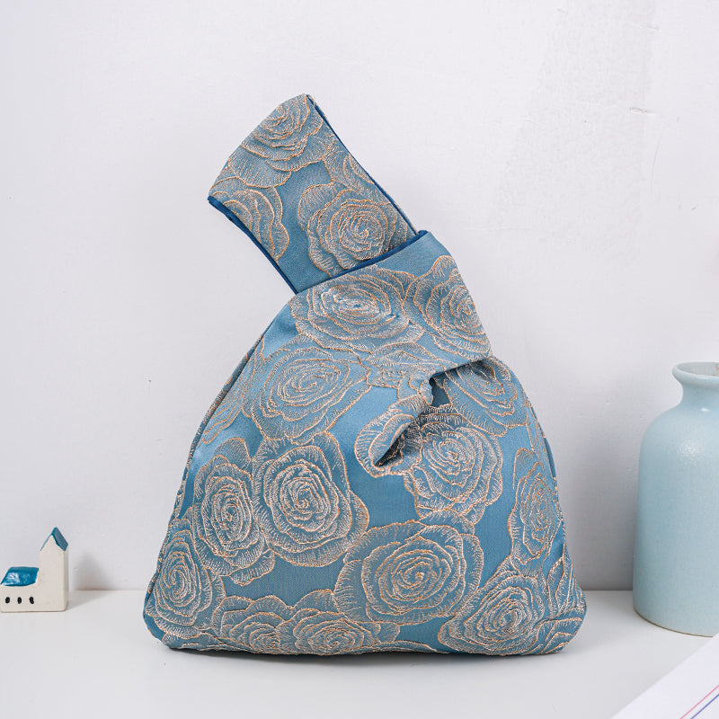 Navy knot bag with raised gold roses