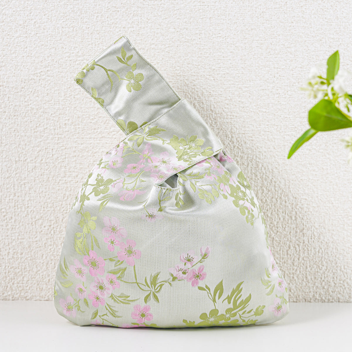Pale green knot bag with pink blossoms