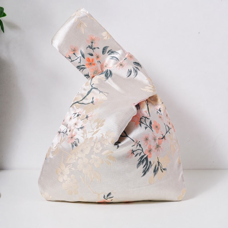 Champagne knot bag with coral-pink blossoms