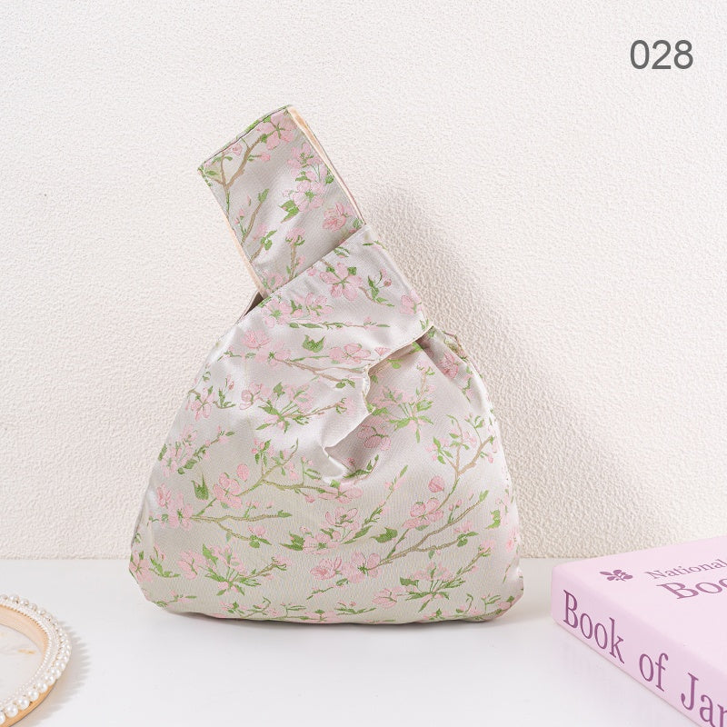 028 Champagne Sakura Japanese knot wrist bag