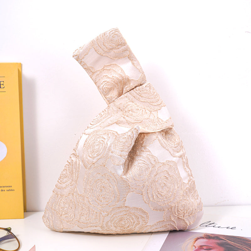 Gold rose satin knot bag with embossed jacquard floral