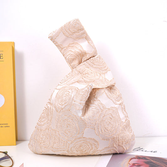 Gold rose satin knot bag with embossed jacquard floral