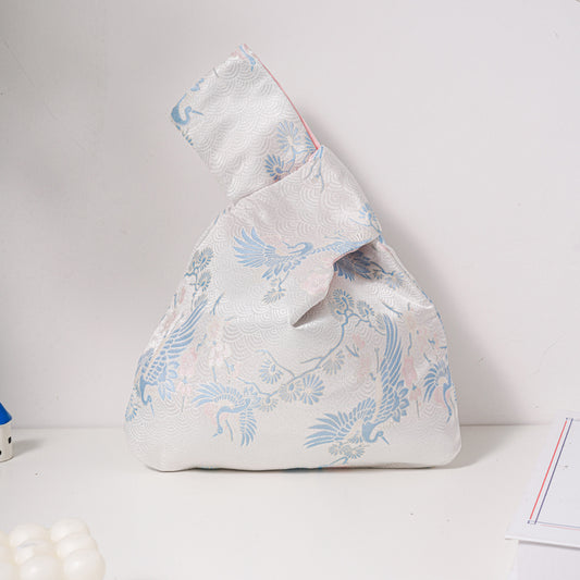 Blue crane brocade knot bag with silver-toned motif