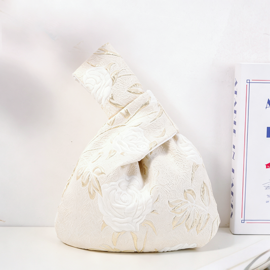 White rose satin knot bag with long-stemmed blooms