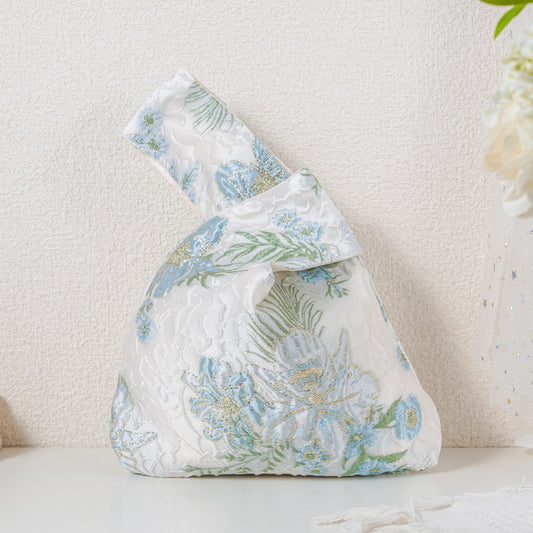 Blue bloom satin knot bag with gold botanical jacquard