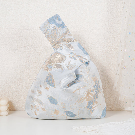 Blue floral satin knot bag with gold botanical jacquard