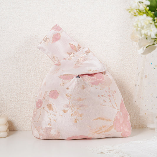 Pink floral satin knot bag with gold botanical jacquard