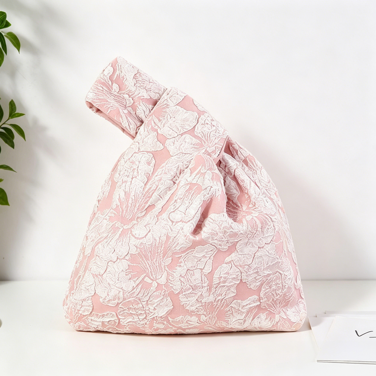 Pink bloom jacquard knot bag with embossed floral